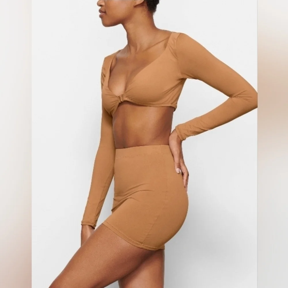 Skims long sleeve shrug.